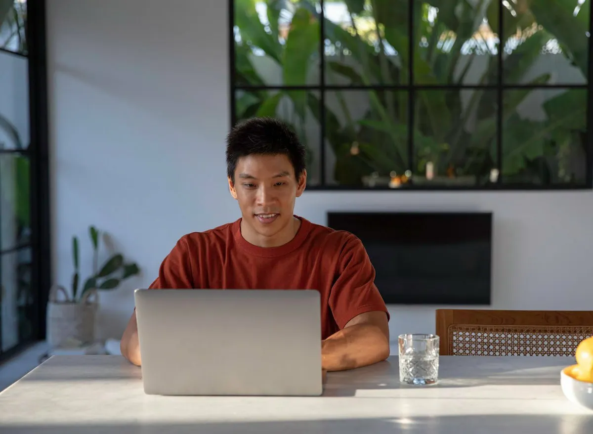 Asian man learning on his computer in an online bootcamp