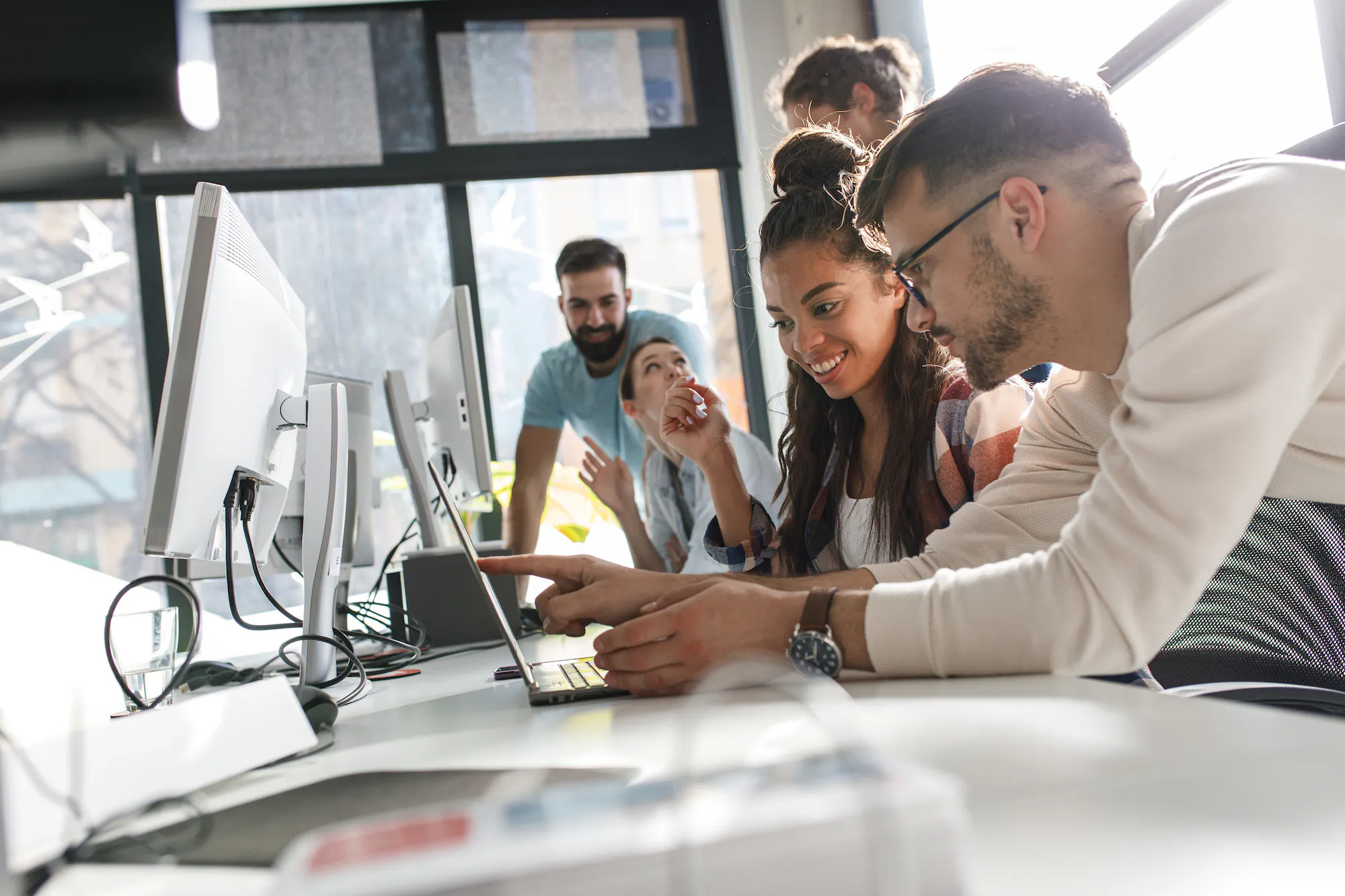 Group looking at laptop together