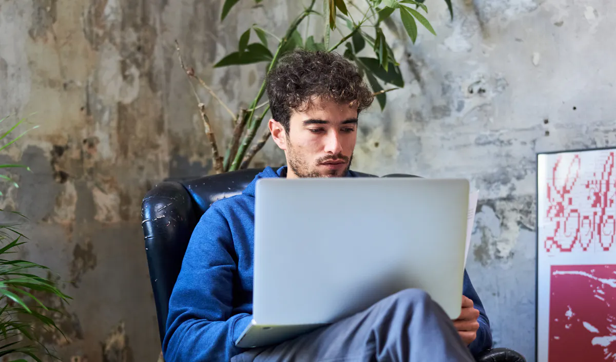 Man studying at laptop card