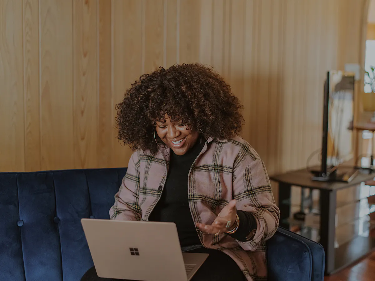 Woman laughing with surface laptop