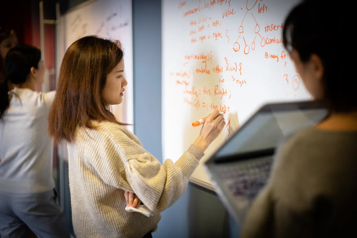 Grace Hopper students whiteboarding coding challenges
