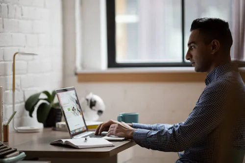 Man Working With Laptop Open 1