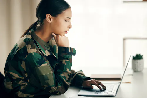 American female soldier working on laptop