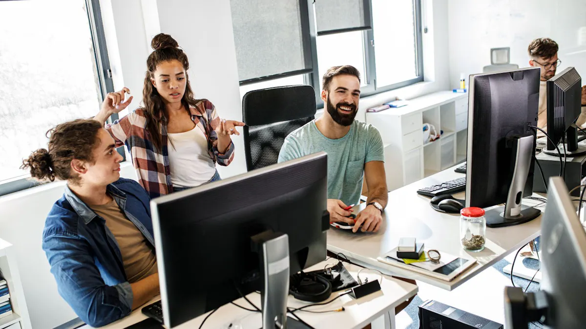 Group of tech workers looking at monitor