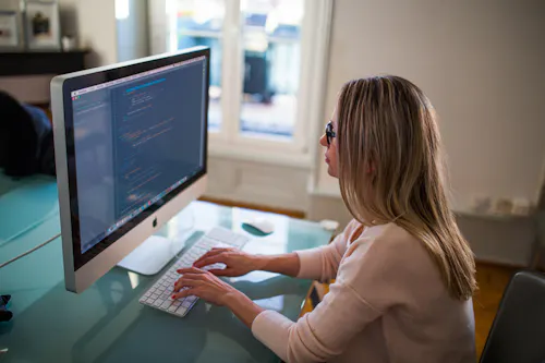 Woman at desk coding