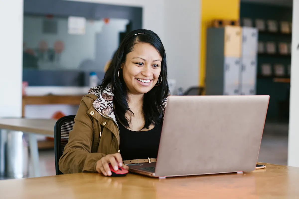 Woman in smiling looking at laptop