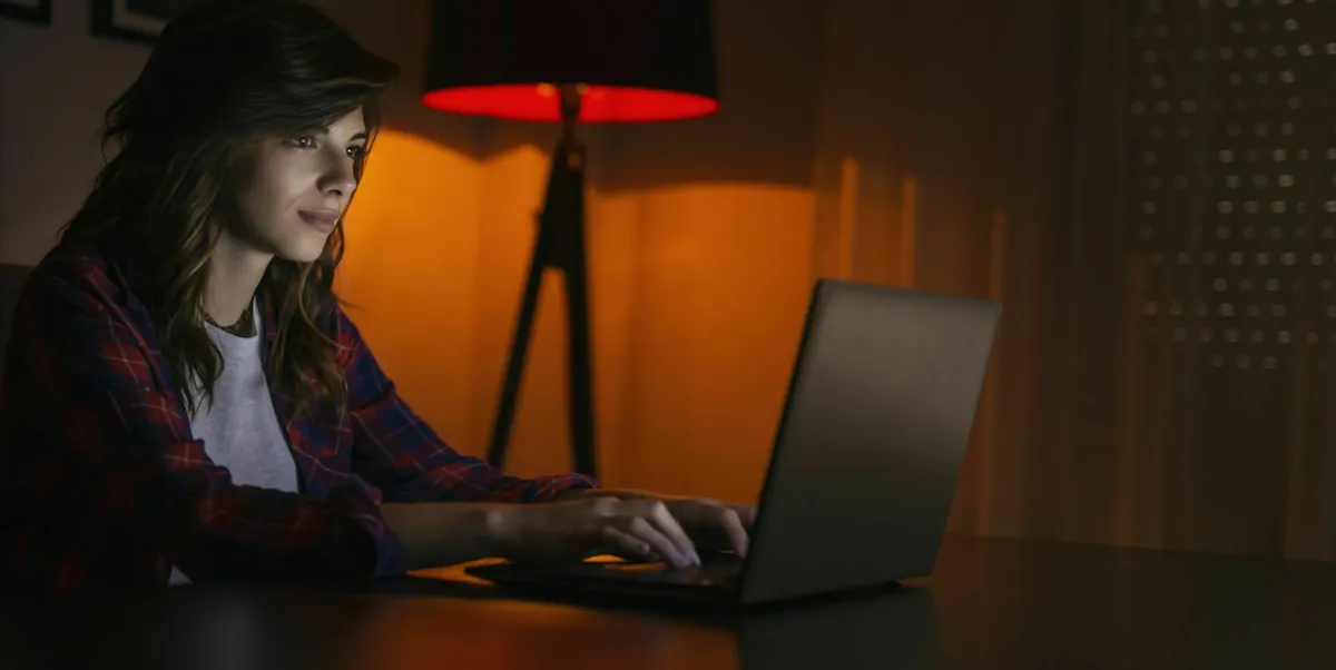 Woman working from home with red light