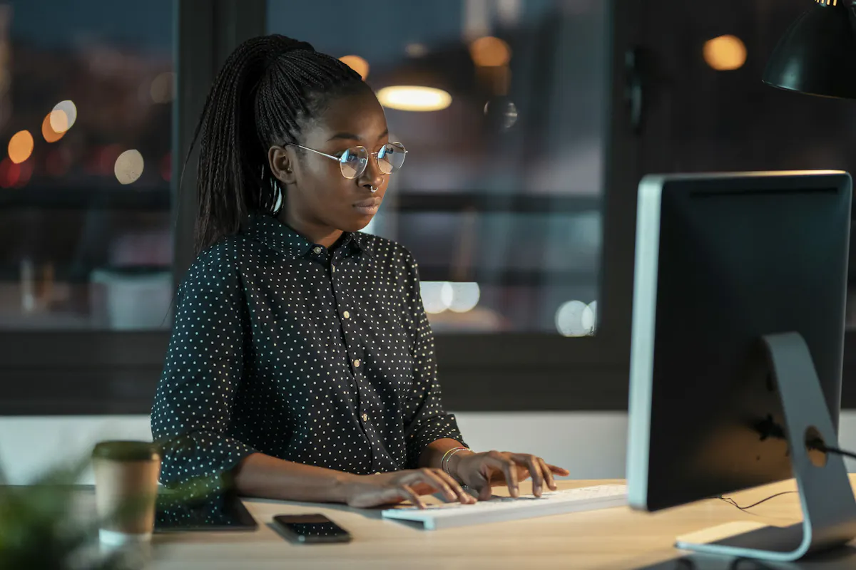 Black woman typing with glasses