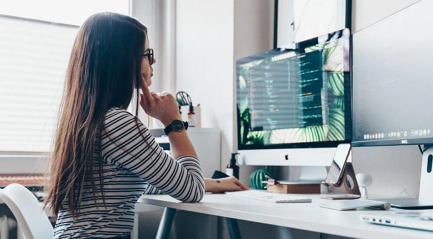 Woman thinking at desktop card
