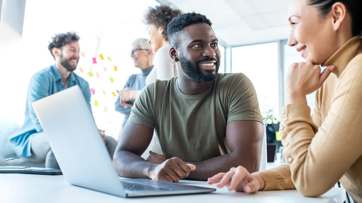 man and woman talking by laptop