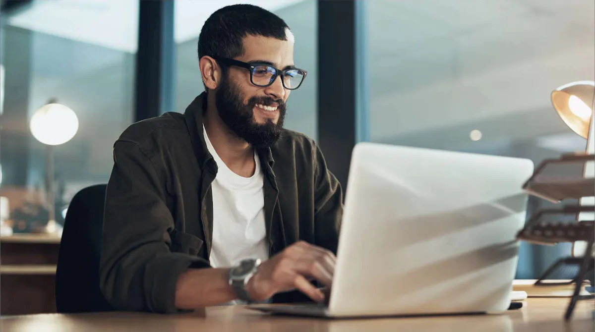 Man smiling at laptop