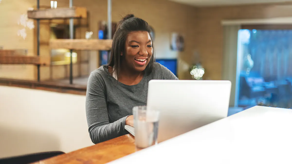 woman in coffee shop smiling at computer
