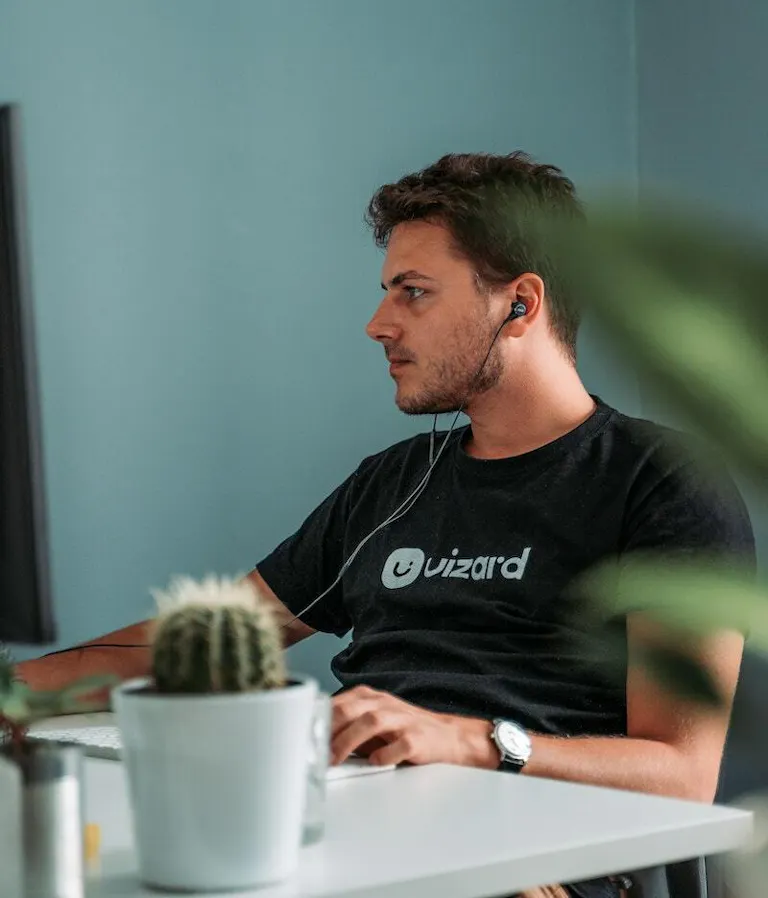 Man working on app with cactus