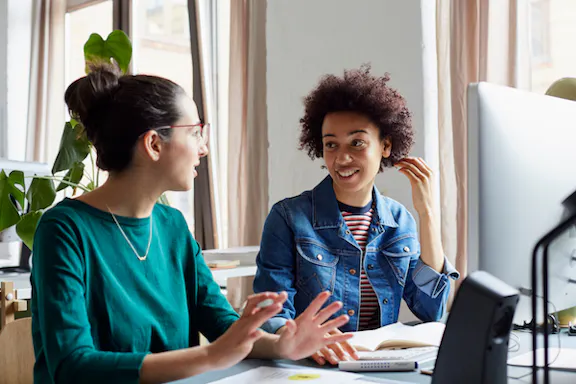 Two women discussing code