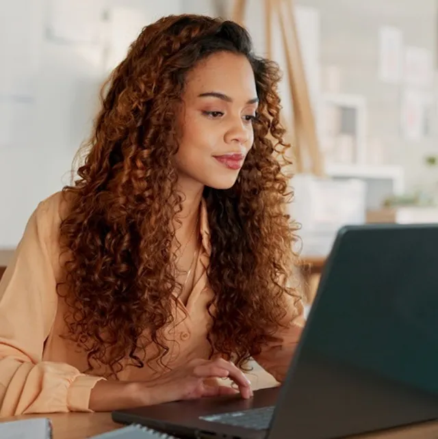 Woman staring intently at laptop